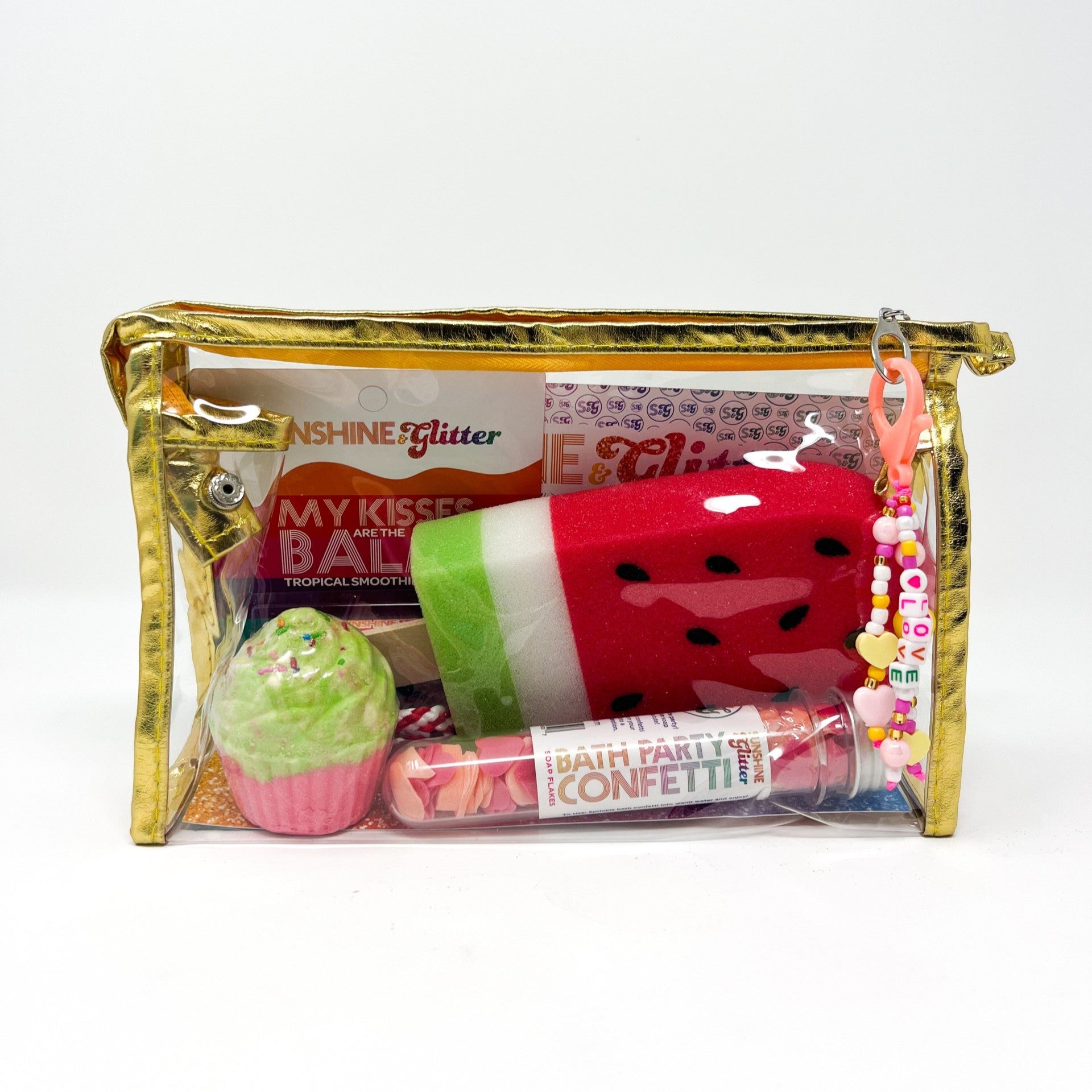 "Sunshine Glitter Watermelon Vibes Bath Set featuring a fizzy cupcake bath bomb with bracelet, organic lip balm, watermelon popsicle sponge, bath confetti, and gold gift bag with cute charm."